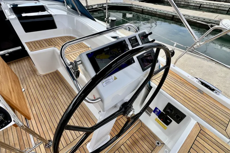 Slide: The Image of Steering wheel and navigation system on 2016 Hanse 455 yacht, docked at marina. - 70