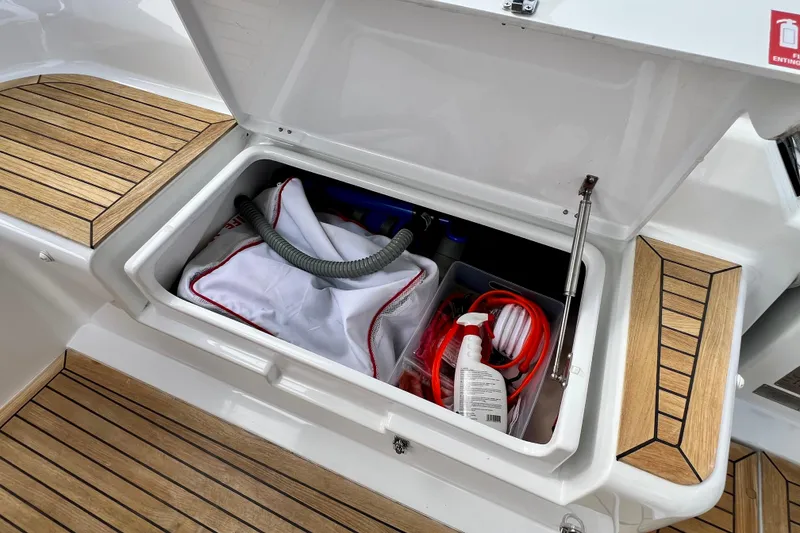 Slide: The Image of Open storage compartment on 2016 Hanse 455 yacht with cleaning supplies and equipment. - 87