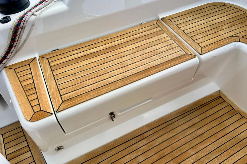 Slide: The Image of Teak deck of 2016 Hanse 455 yacht, featuring sleek wooden finish and nautical ropes. - 88