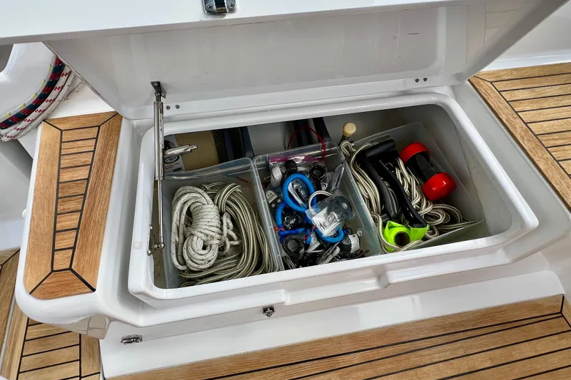 Slide: The Image of Storage compartment on a 2016 Hanse 455 yacht, containing ropes and sailing gear. - 89