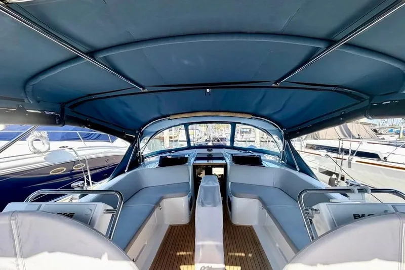 Slide: The Image of Interior view of 2016 Hanse 455 yacht cockpit with blue canopy and seating. - 93