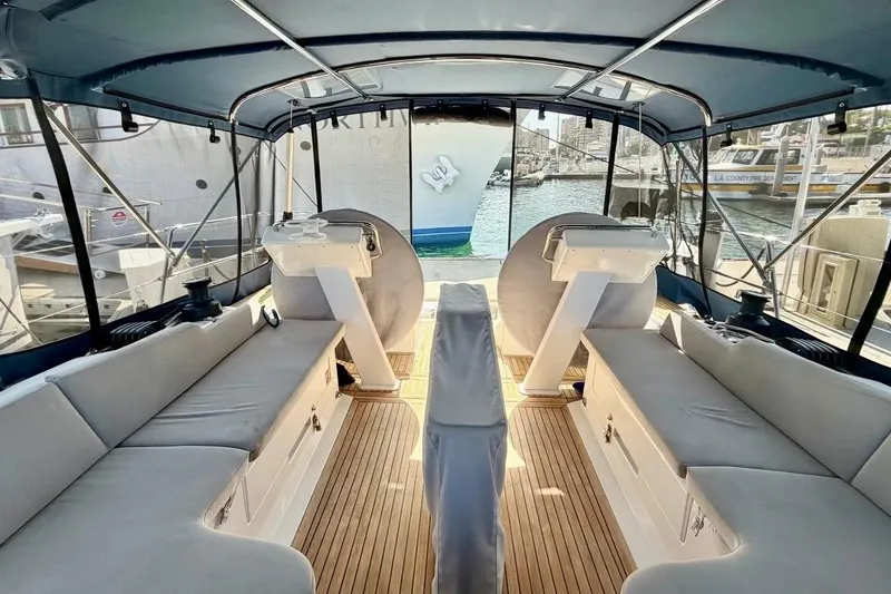 Slide: The Image of Spacious cockpit of 2016 Hanse 455 yacht with comfortable seating and marina view. - 94