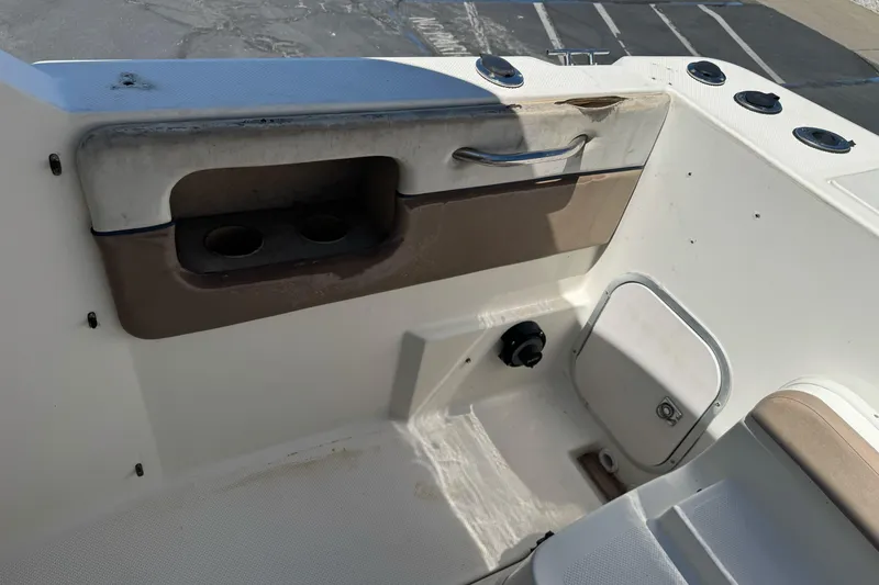 Slide: The Image of 2005 Bayliner 222 Classic boat interior with cup holders and storage compartment. - 15