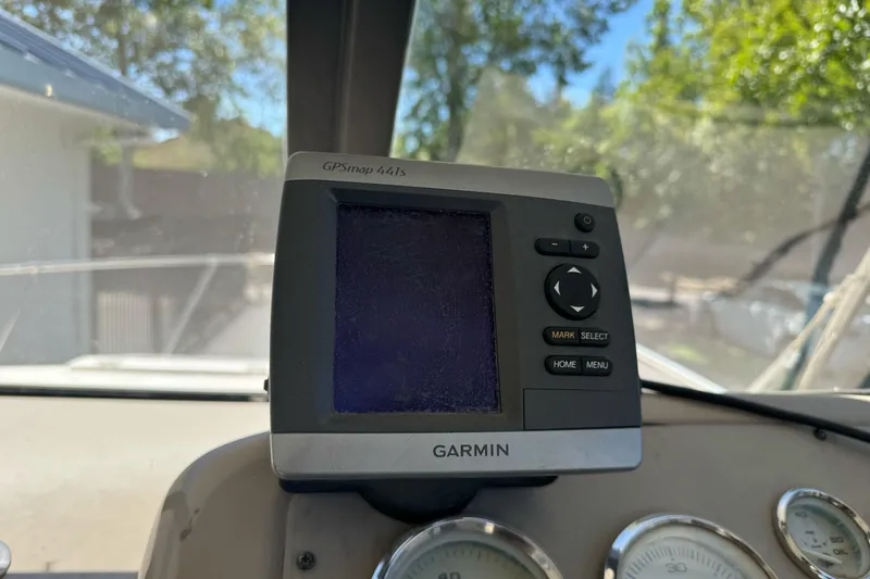 Slide: The Image of Garmin GPSmap 441s on 2005 Bayliner 222 Classic dashboard, surrounded by gauges. - 20