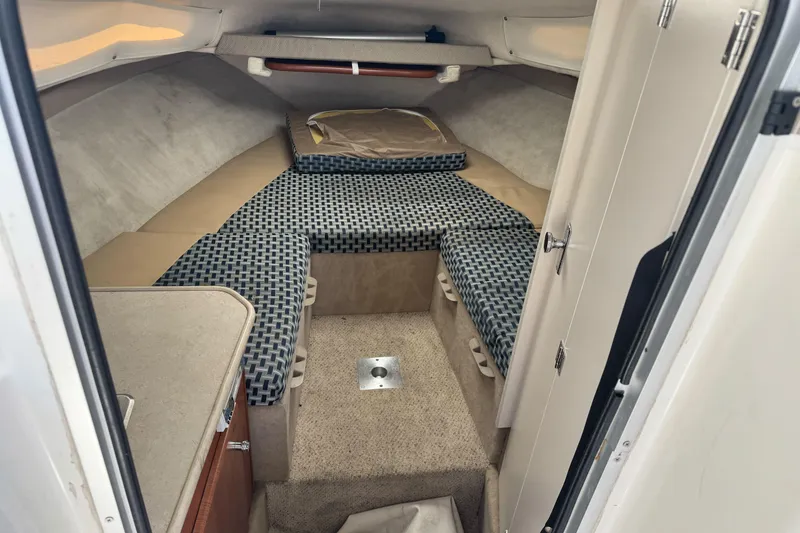 Slide: The Image of Interior cabin of a 2005 Bayliner 222 Classic boat with cushioned seating. - 21