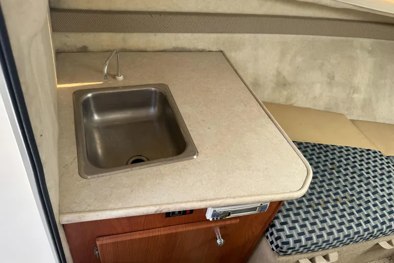 Slide: The Image of 2005 Bayliner 222 Classic boat interior with sink and seating area. - 22