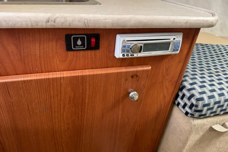 Slide: The Image of Interior of 2005 Bayliner 222 Classic boat with water switch and stereo system. - 24