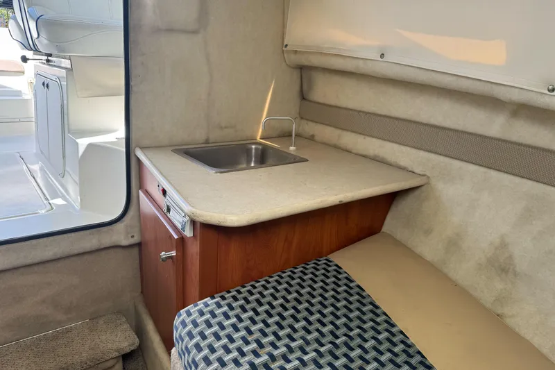 Slide: The Image of Interior of 2005 Bayliner 222 Classic boat with compact kitchenette and seating area. - 30