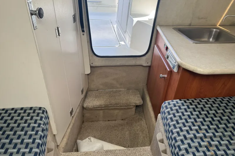 Slide: The Image of Interior of 2005 Bayliner 222 Classic boat with seating, sink, and storage. - 31