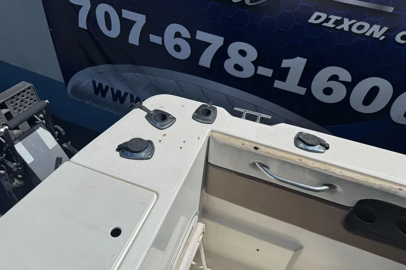 Slide: The Image of 2005 Bayliner 222 Classic boat deck with fittings and handle, displayed outdoors. - 35