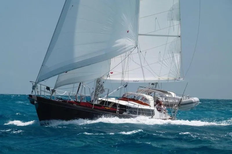 The Image of Sailing yacht Hutting 40' from 1994 navigating through blue ocean waters. - 0