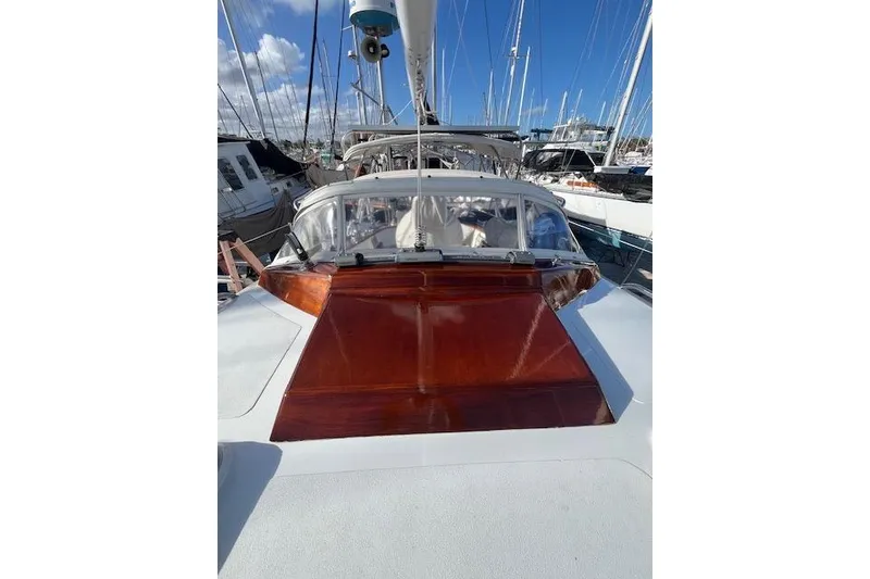 Slide: The Image of 1994 Hutting 40' sailboat with polished wood details, docked in a marina. - 10