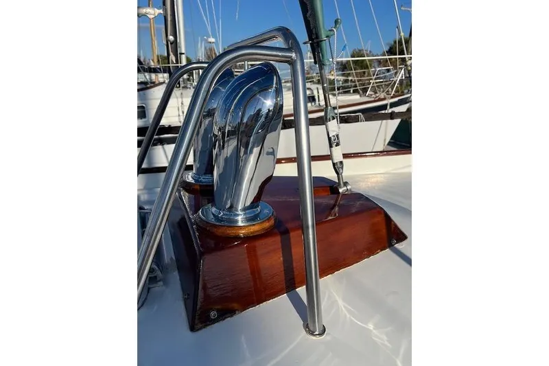 Slide: The Image of Polished chrome fittings on a 1994 Hutting 40' sailboat deck, with wooden accents. - 13