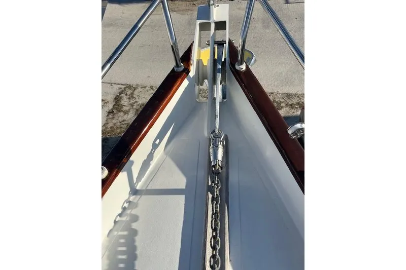 Slide: The Image of Bow of a 1994 Hutting 40' sailboat with anchor chain and polished railings. - 16