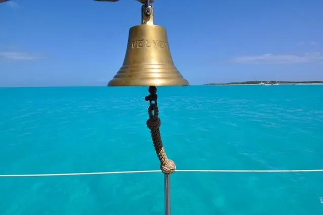 Slide: The Image of Golden bell on a 1994 Hutting 40' sailboat against turquoise sea and clear sky. - 18