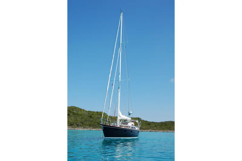 Slide: The Image of Sailboat on calm water, Hutting 40', 1994 model, clear blue sky background. - 2