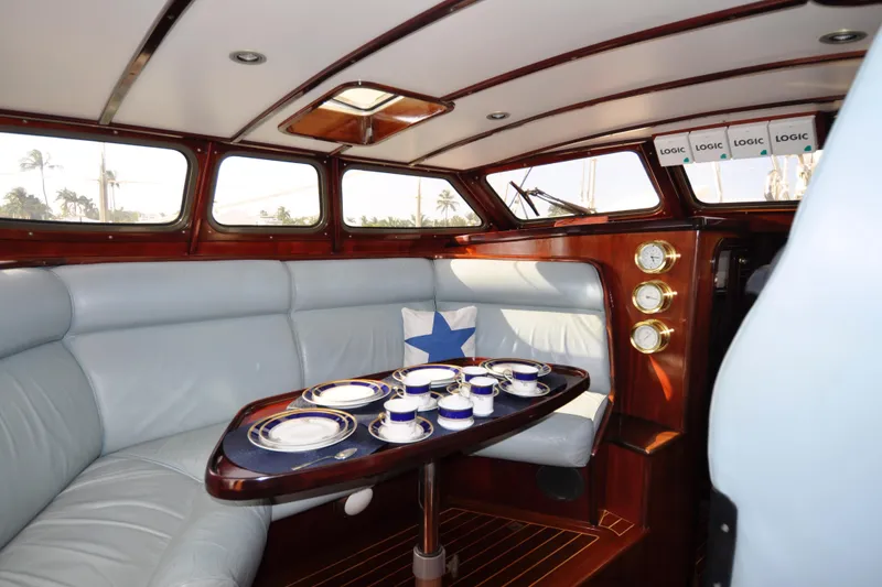 Slide: The Image of Luxurious 1994 Hutting 40' yacht interior with elegant dining setup and plush seating. - 21