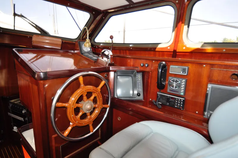 Slide: The Image of Luxurious 1994 Hutting 40' yacht interior with wooden helm and navigation equipment. - 22