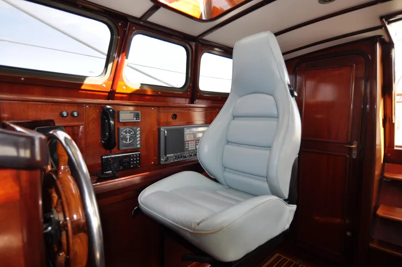Slide: The Image of Interior of a 1994 Hutting 40' yacht with a luxurious captain's chair and navigation equipment. - 23