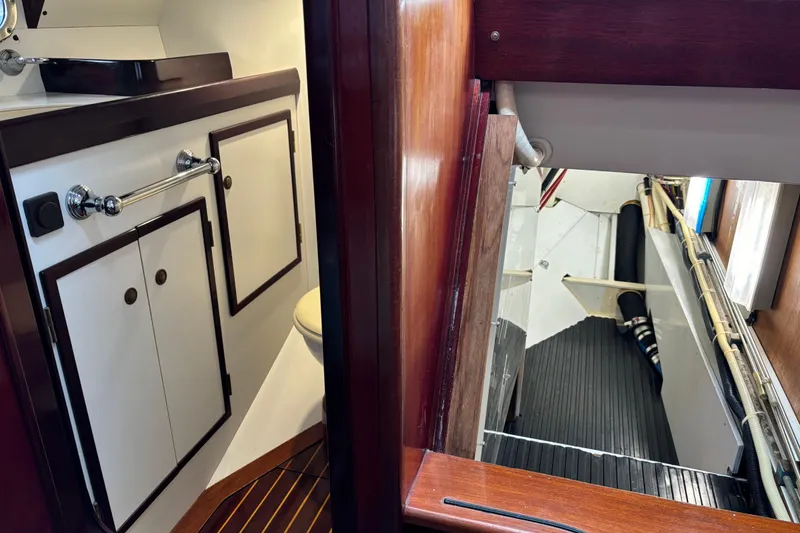 Slide: The Image of Interior of a 1994 Hutting 40' yacht showing bathroom and engine room access. - 26