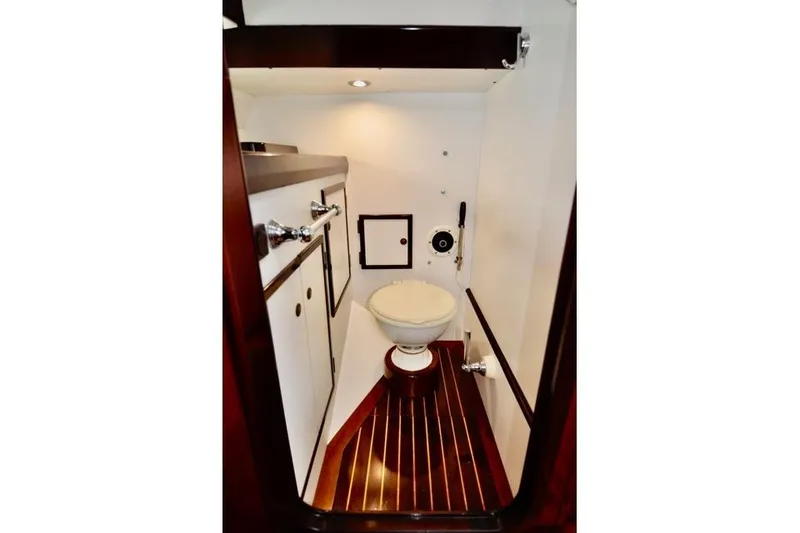 Slide: The Image of Interior of 1994 Hutting 40' yacht bathroom with wooden flooring and white fixtures. - 27