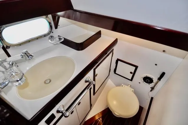 Slide: The Image of Luxurious bathroom interior of a 1994 Hutting 40' yacht, featuring sink and toilet. - 28