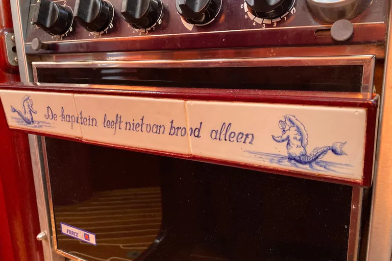 Slide: The Image of Vintage Hutting 40' 1994 oven with nautical-themed Dutch tile design. - 32