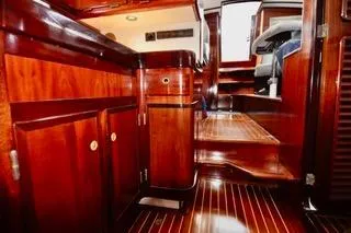 Slide: The Image of Luxurious wooden interior of a 1994 Hutting 40' yacht, showcasing elegant cabinetry and flooring. - 33
