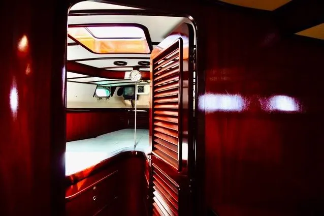 Slide: The Image of Luxurious wooden interior of a 1994 Hutting 40' yacht cabin with elegant finishes. - 37