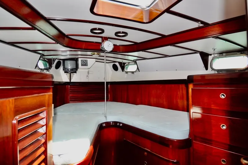 Slide: The Image of Luxurious 1994 Hutting 40' yacht interior with rich wood finish and cozy sleeping area. - 38