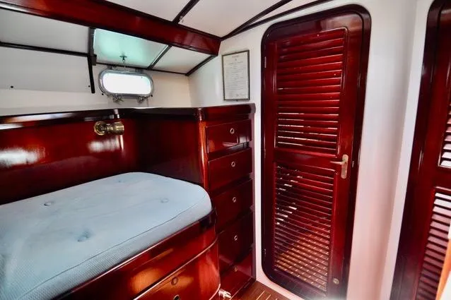 Slide: The Image of Luxurious wooden cabin interior of a 1994 Hutting 40' yacht with bed and storage. - 39