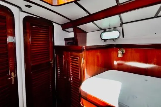 Slide: The Image of Luxurious 1994 Hutting 40' yacht interior with polished wood finish and cozy cabin. - 40