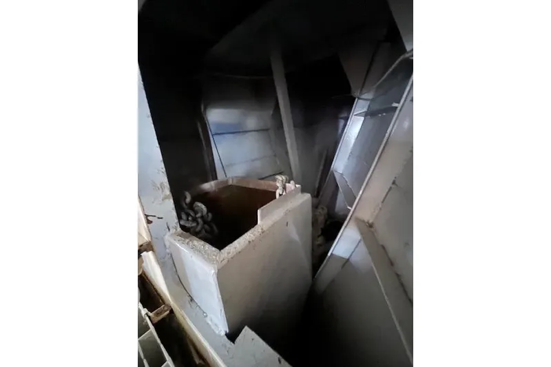 Slide: The Image of Interior view of a 1994 Hutting 40' boat, showcasing storage compartments and equipment. - 43