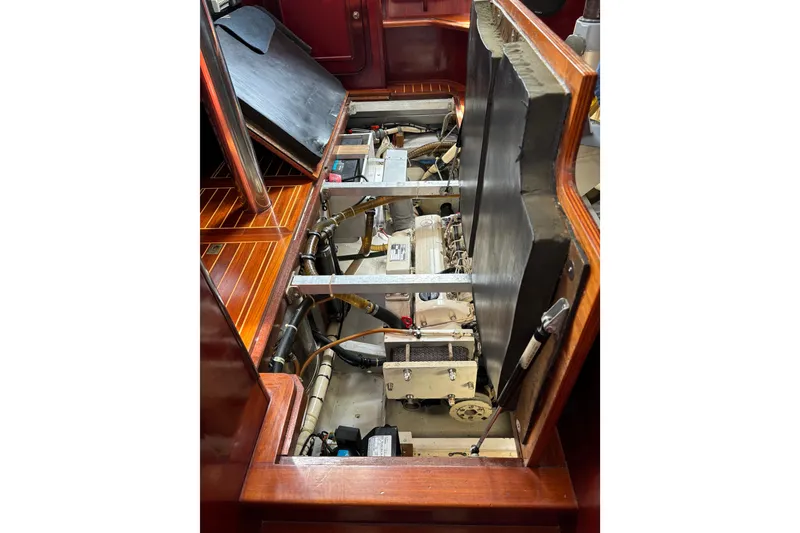 Slide: The Image of Engine compartment of a 1994 Hutting 40' yacht with visible mechanical components. - 46