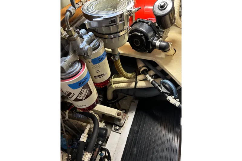 Slide: The Image of Engine room of a 1994 Hutting 40' yacht with filters and hoses visible. - 47