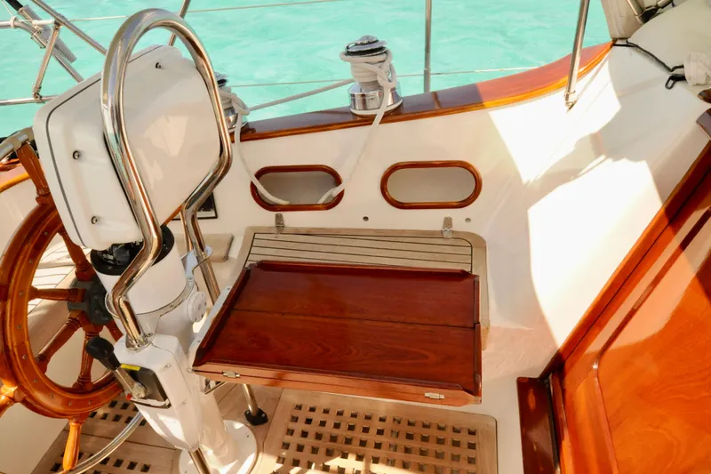 Slide: The Image of Interior of a 1994 Hutting 40' yacht with wooden accents and steering wheel. - 5