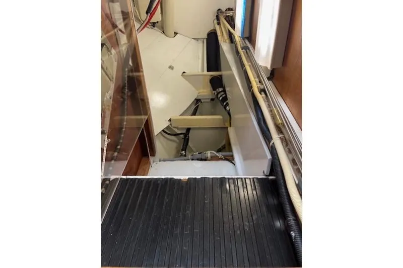 Slide: The Image of Interior view of a 1994 Hutting 40' boat, showcasing mechanical components and piping. - 50