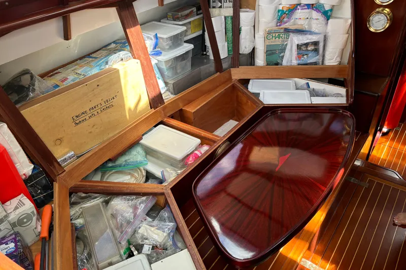 Slide: The Image of Interior of a 1994 Hutting 40' yacht with organized storage and polished wood table. - 52