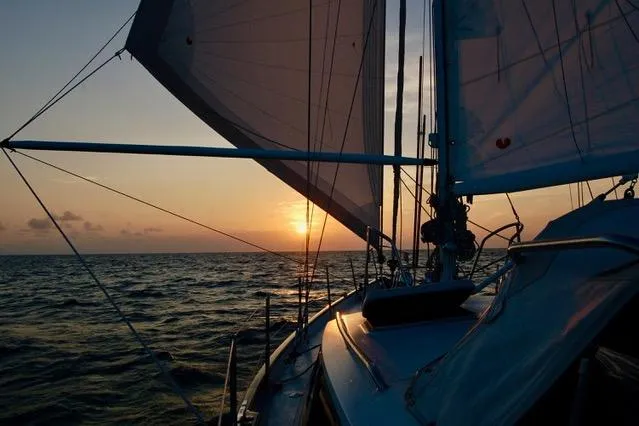 Slide: The Image of Sailing at sunset on a 1994 Hutting 40' yacht, ocean horizon view. - 58