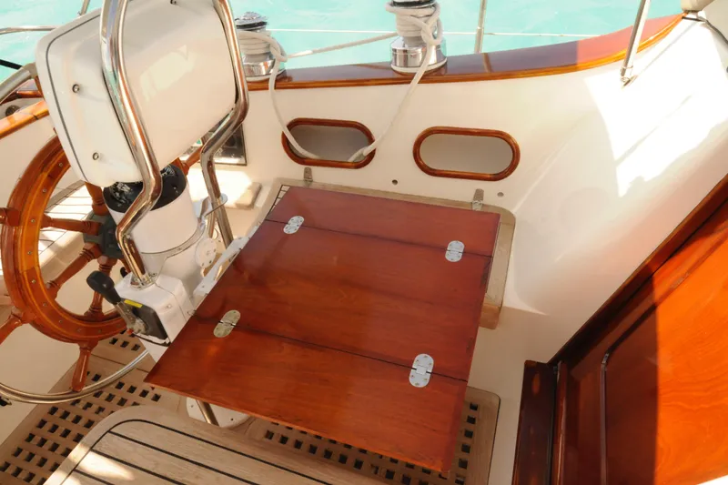 Slide: The Image of Cockpit of 1994 Hutting 40' sailboat with wooden table and steering wheel. - 6
