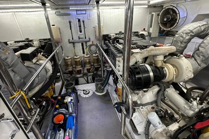 Slide: The Image of Engine room of a 2004 Mikelson 61 PH yacht, showcasing machinery and equipment. - 10