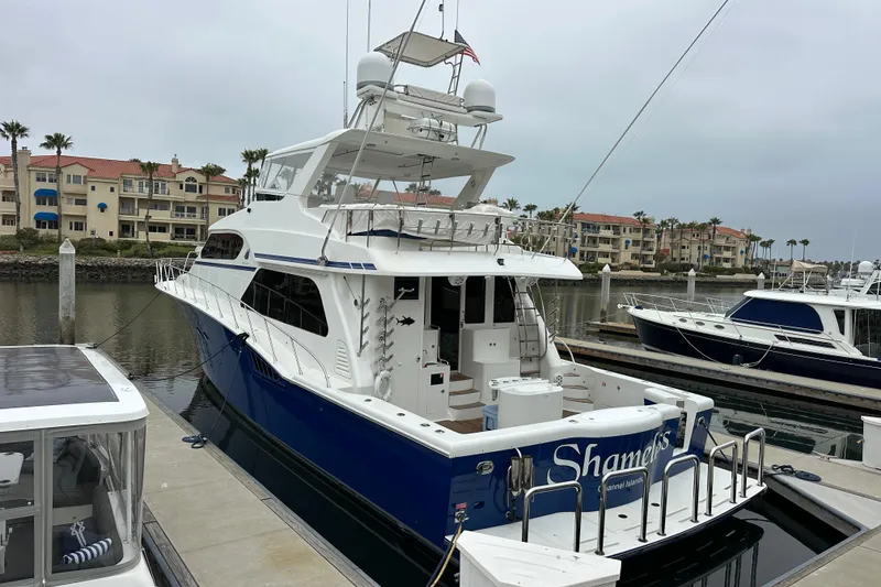 Slide: The Image of Luxury 2004 Mikelson 61 PH yacht docked in marina, surrounded by waterfront buildings. - 3