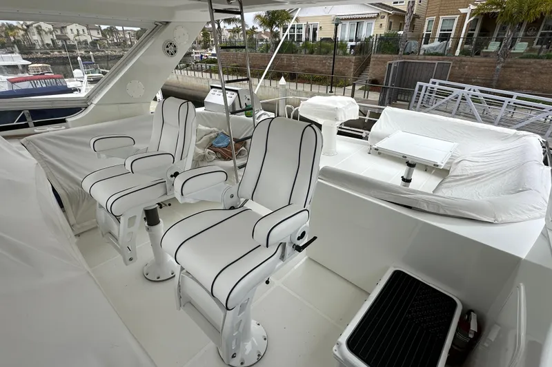Slide: The Image of Luxurious 2004 Mikelson 61 PH yacht interior with white seating and modern design. - 5
