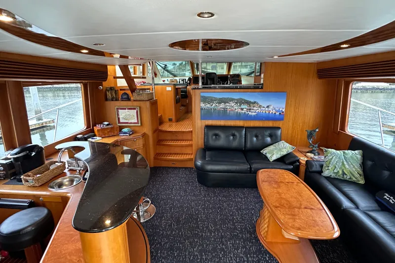 Slide: The Image of Luxurious interior of a 2004 Mikelson 61 PH yacht with elegant seating and modern amenities. - 6