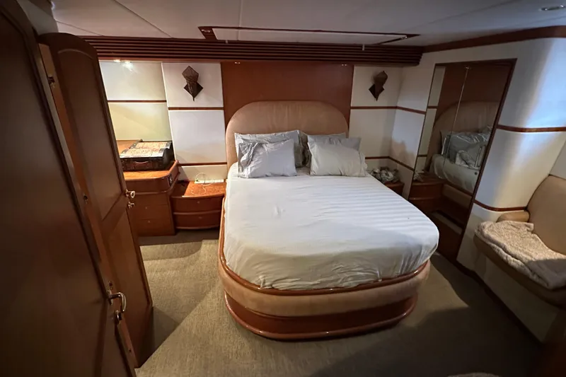 Slide: The Image of Luxurious bedroom interior of 2004 Mikelson 61 PH yacht with elegant wood finishes. - 7
