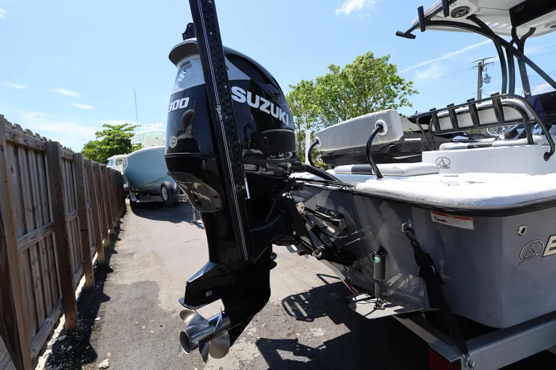 Slide: The Image of 2021 Blazer Bay 2400 boat with Suzuki outboard motor, parked outdoors. - 10