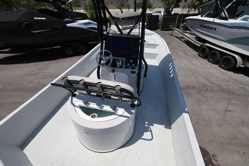 Slide: The Image of 2021 Blazer Bay 2400 boat interior with steering console and rod holders. - 14