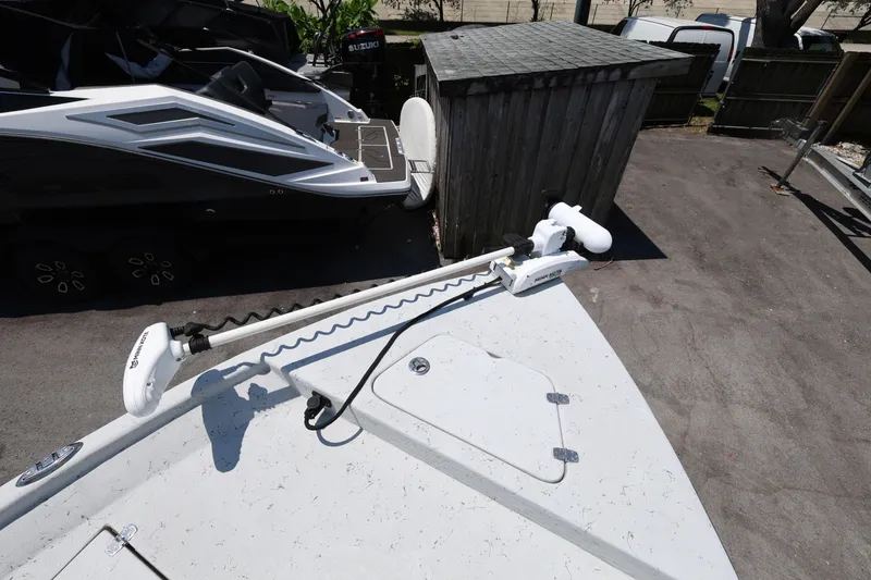 Slide: The Image of 2021 Blazer Bay 2400 boat with Minn Kota trolling motor in a parking area. - 20
