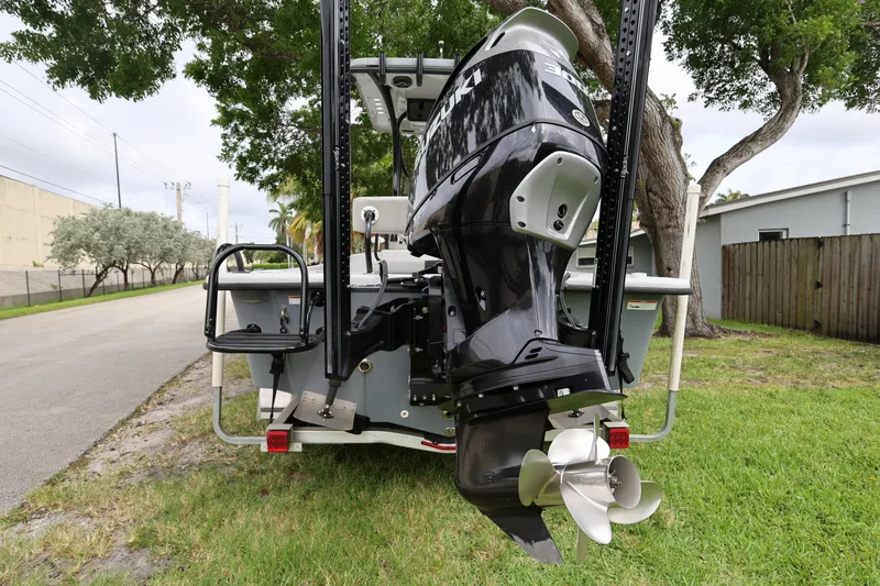 Slide: The Image of 2021 Blazer Bay 2400 boat with powerful outboard motor, parked on grass. - 4