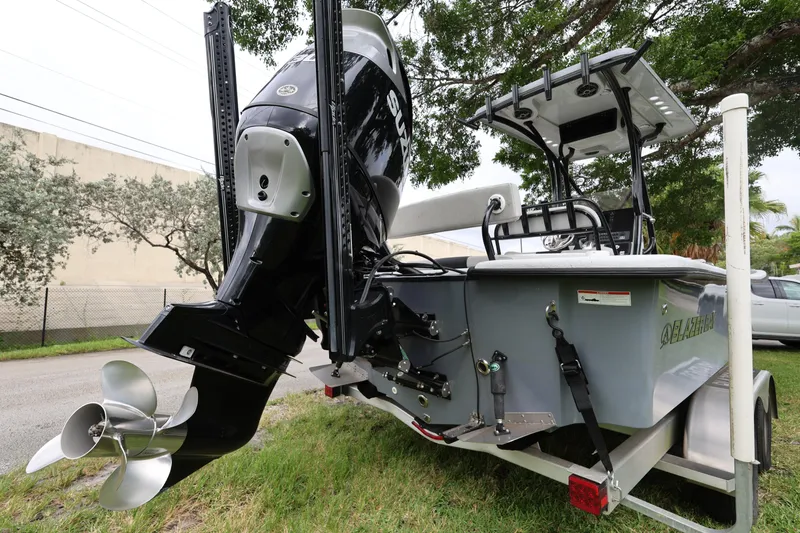 Slide: The Image of 2021 Blazer Bay 2400 boat with powerful outboard motor, parked on a trailer. - 5